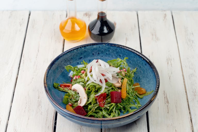 Healthy vegetable salad with organic ingredients, photographed in a Dubai kitchen setting.